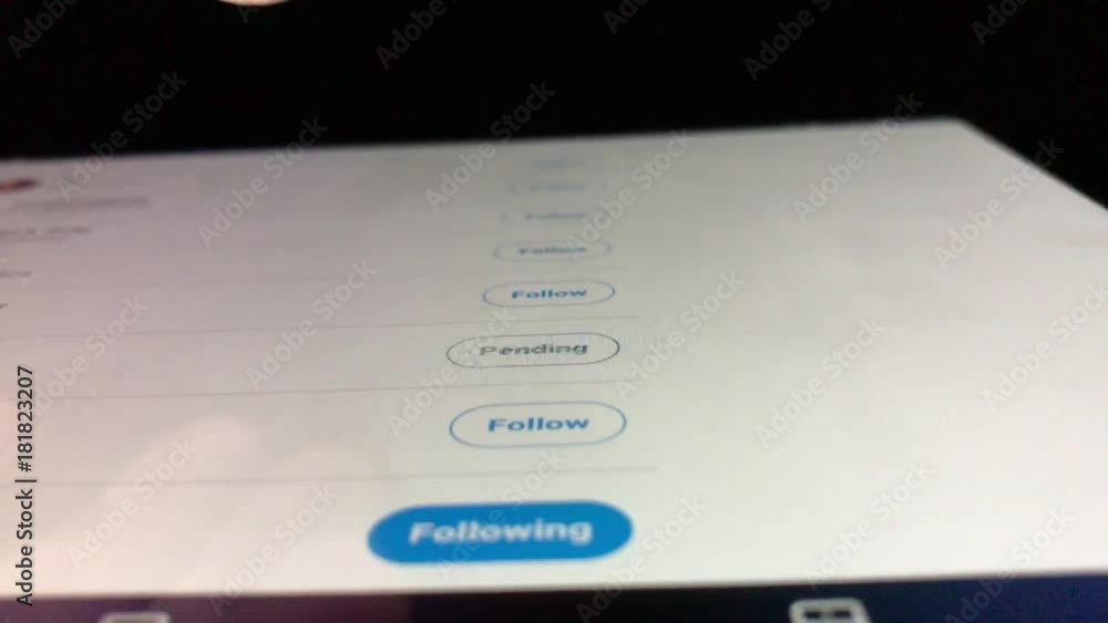 Close up of finger hitting follow buttons on social media with tablet angled away. Close up of finger hitting follow buttons on social media with tablet angled away.