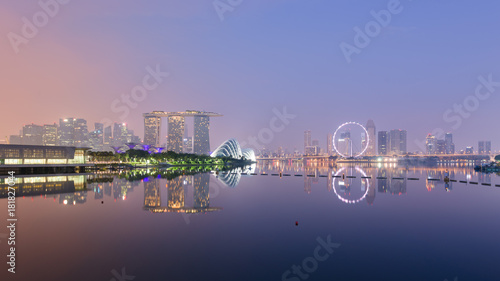 Singapore skyline with CBD, Central Business District, Gardens by the Bay, Sands hotel and Flyer wheel reflecting in Marina Bay, at sunrise, from the Barrage.