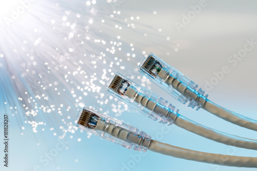 Closeup of RJ45 UTP LAN on the background of optical fibers with blurred lights