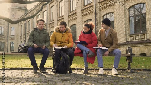 Four friends dicussing future exams at university photo