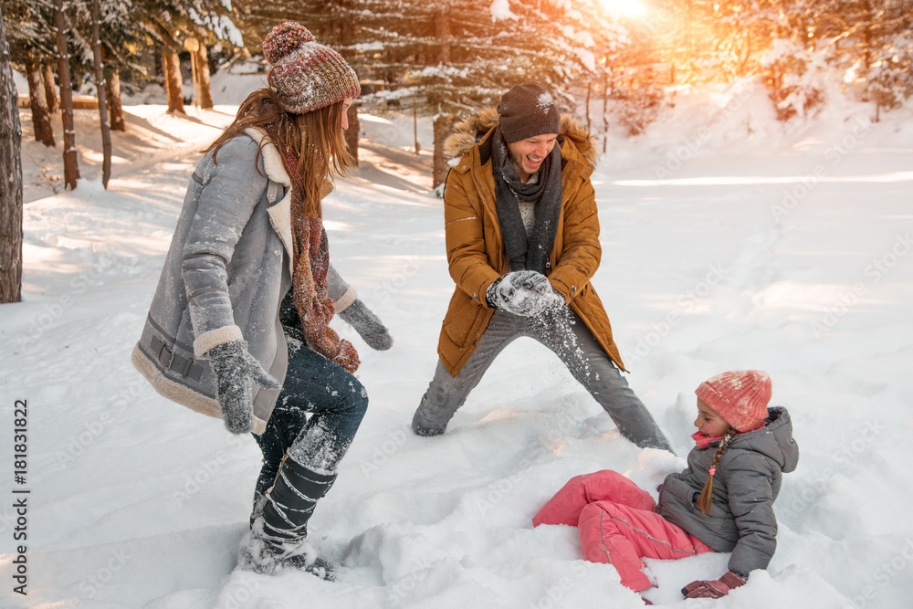 funny wintertimes with parents and child - obrazy, fototapety, plakaty 