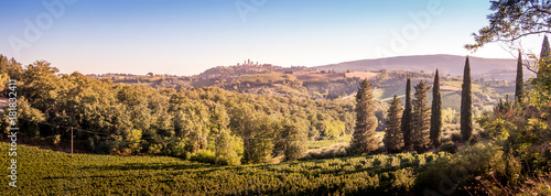 San Gimignano medieval town towers skyline and countryside landscape panorama on sunset. Tuscany, Italy, Europe