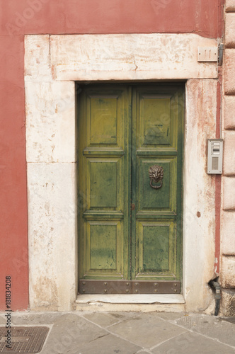 Wooden door with marble decorations © cristianstorto