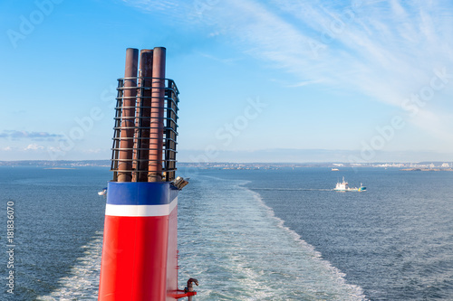 Obraz na płótnie Chimney at a ship sailing a a blue sea
