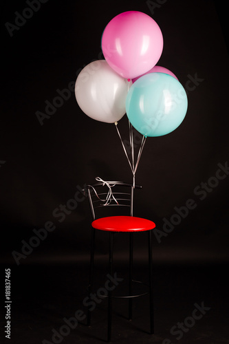 white blue pink balloons on a black background photo