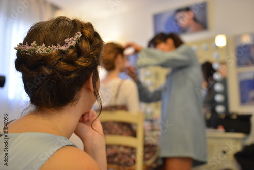 A bride on her wedding day after make up and hair styling with white dress taking photo shots photo