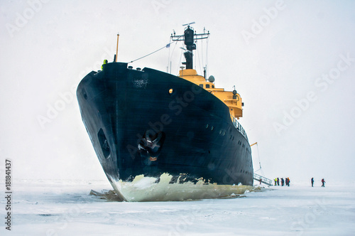 giant black ice breaker ship,in the ice cold water of the north ocean