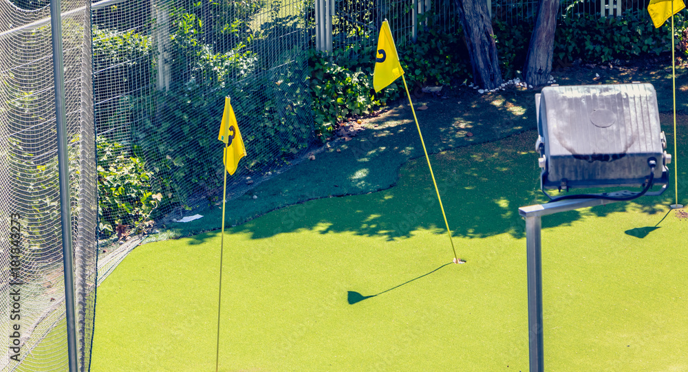 mini golf practice in town with green and flags
