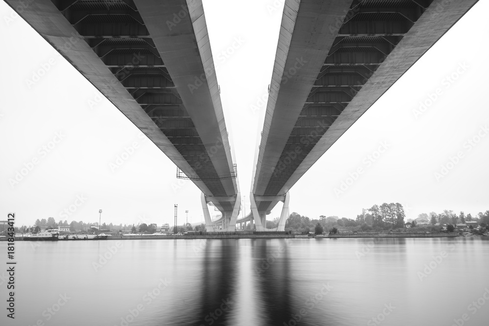 Cable-stayed bridge in Saint Petersburg. Bridge over Neva river in Saint-Petersburg, Russia. Fog night city. Cable-stayed bridge in Saint Petersburg. Bridge over Neva river in Saint-Petersburg, Russia. Fog night city.