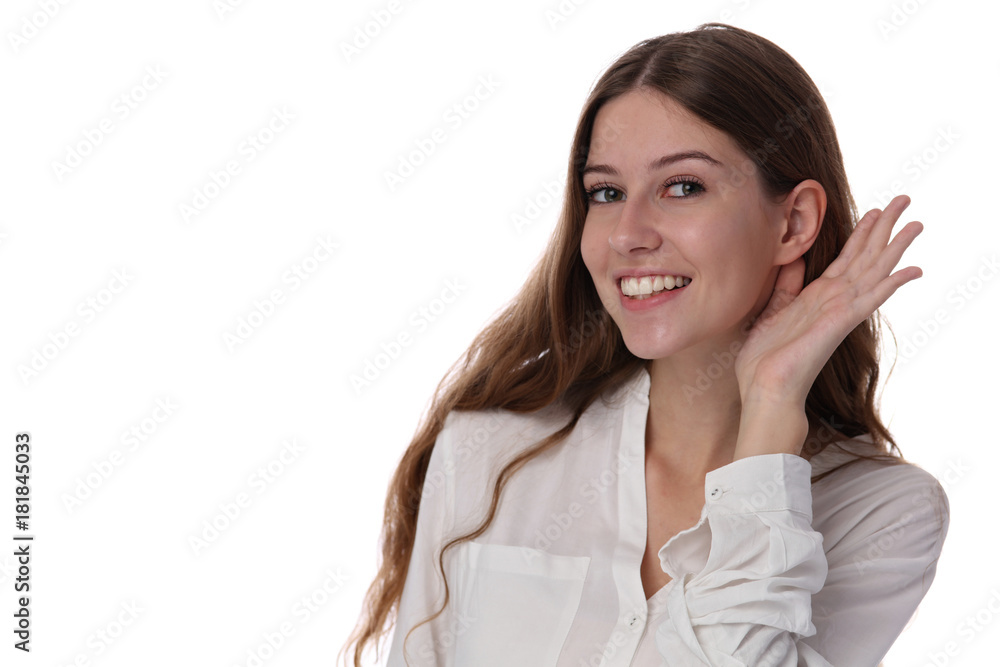 Portrait of happy smiling teenage girl putting a hand to the ear to hear better, making listening gesture. Rumors and gossips concept Portrait of happy smiling teenage girl putting a hand to the ear to hear better, making listening gesture. Rumors and gossips concept
