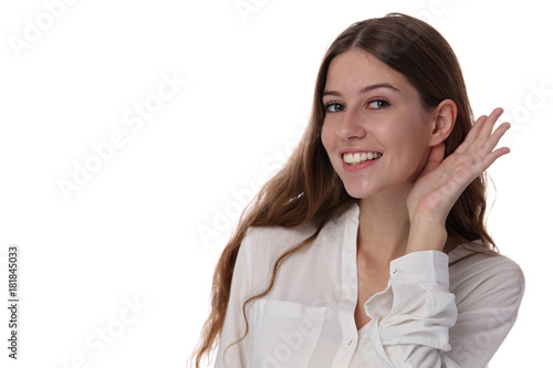 Portrait of happy smiling teenage girl putting a hand to the ear to hear better, making listening gesture. Rumors and gossips concept