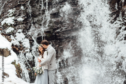 bride and groom on the mountain waterfall
