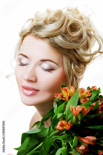 Beautiful blond girl with flowers on a white background.