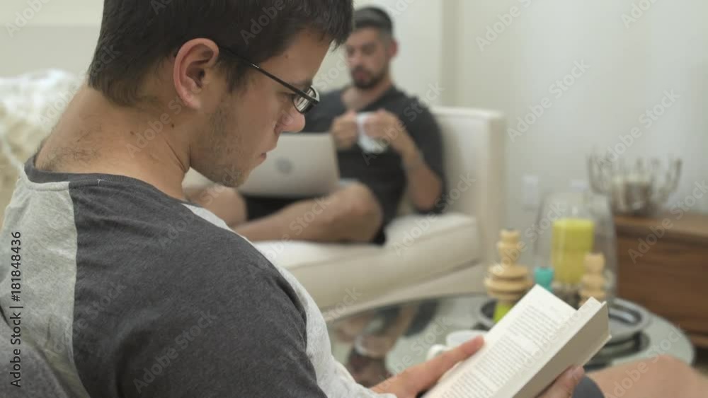 Medium close-up shot of a man reading at home Medium close-up shot of a man reading at home