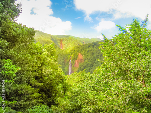 Scenic landscape in tropical rainforest of Carbet Falls or Les Chutes du Carbet, on Carbet River, Guadeloupe island, Caribbean, French Antilles. The waterfalls are one of the most popular landmarks. photo