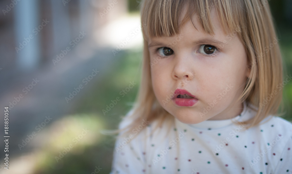Closeup portrait of confused little girl wizh lipstick Closeup portrait of confused little girl wizh lipstick