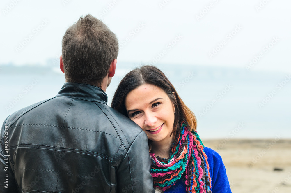 the guy with the girl walking in autumn Park. deserted beach , dirty sand .stand back . the guy with the girl walking in autumn Park. deserted beach , dirty sand .stand back .