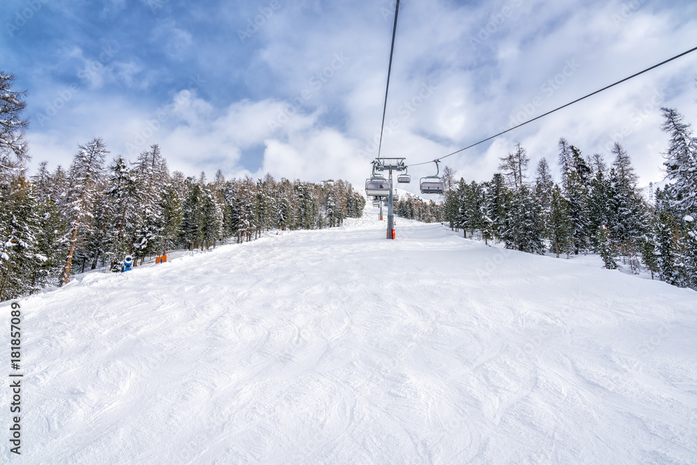 Empty ski slope, winter landscape with ski lift