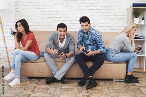 Two guys and two girls play on the game console.