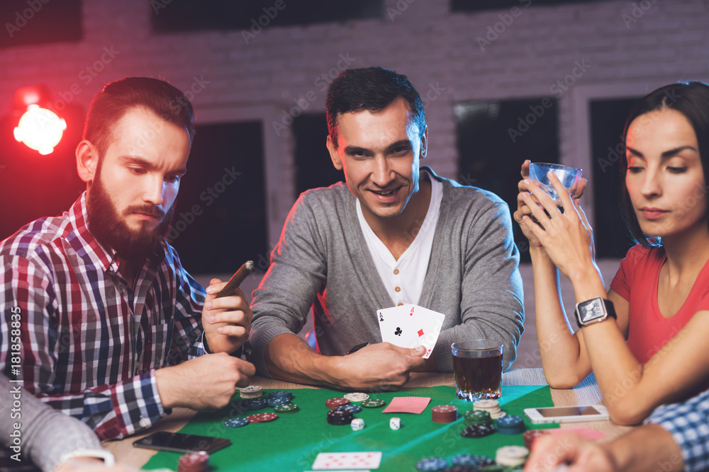 Young people play poker at the table. Young people play poker at the table.