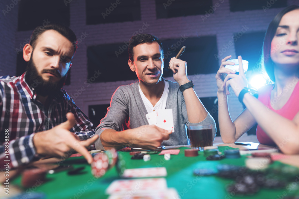Young people play poker at the table. Young people play poker at the table.