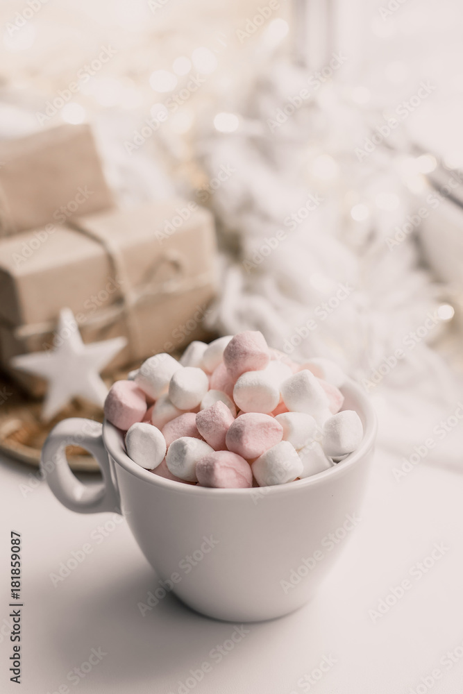 Cup of hot chocolate and marshmallow in the background of Christmas decorations. Cup of hot chocolate and marshmallow in the background of Christmas decorations.