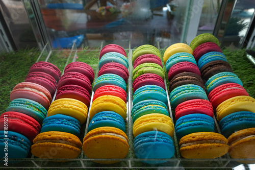Colorful macaroon cookies in the plate on blue background,selective focus 