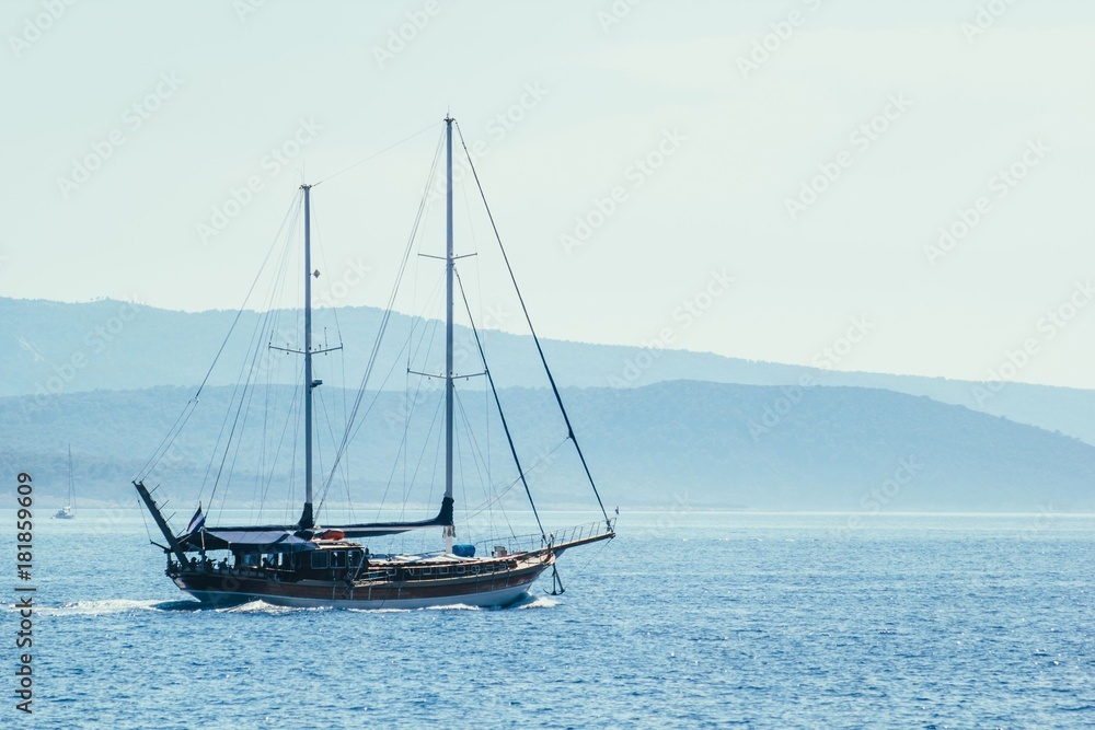 Sailboat on blue sea background