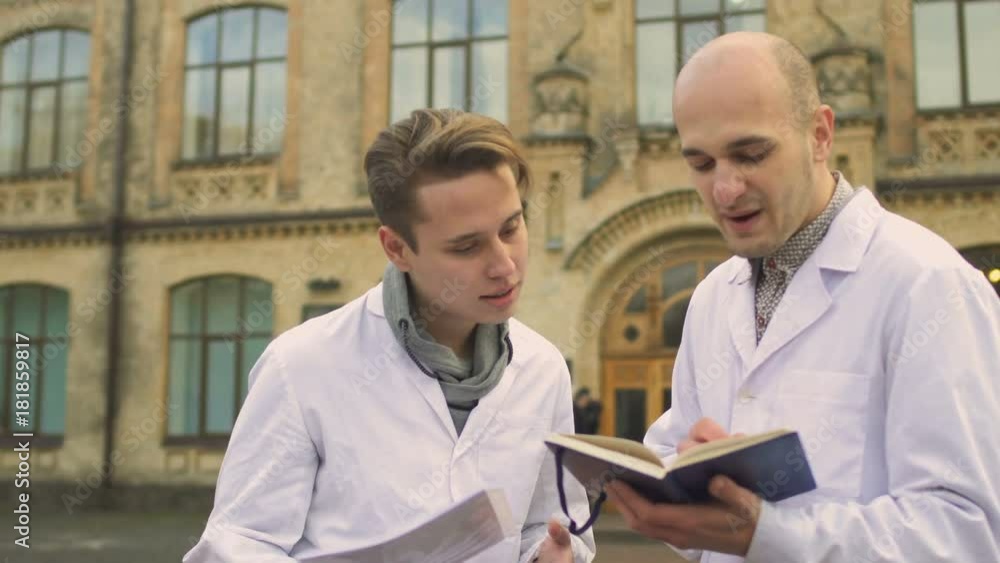 Two medical students discuss something near university
