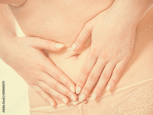 Woman in lingerie with stomach pain