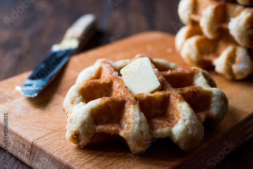 Belgium Waffle with Butter on wooden surface.