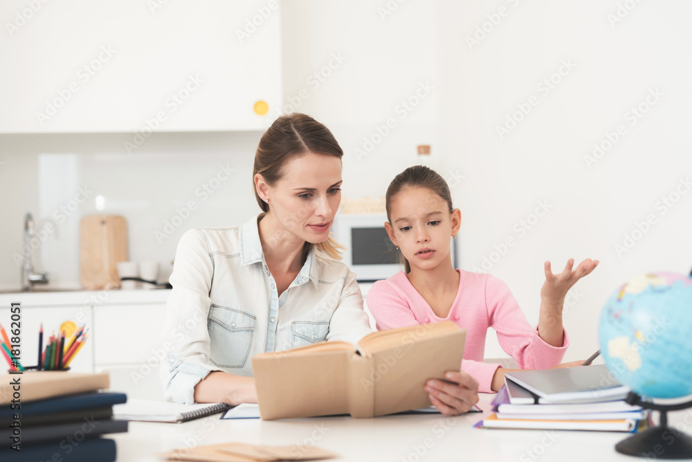 Mom helps my daughter do her homework in the kitchen. Mom helps my daughter do her homework in the kitchen.