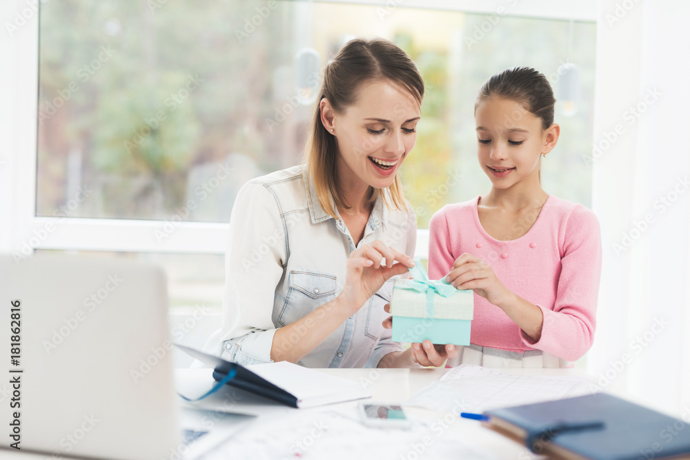 Working woman on maternity leave. The daughter made a present for her beloved mother. Working woman on maternity leave. The daughter made a present for her beloved mother.