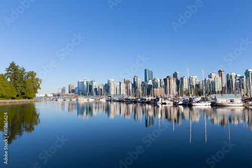Vancouver skyline as seen from Stanley Park. Urban downtown panorama with Canada Place colorful sails along the coastal harbor line.