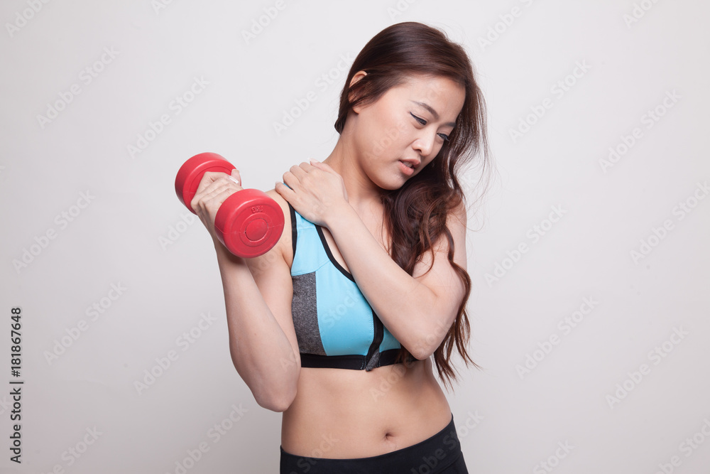Asian healthy girl got shoulder pain with dumbbell. Asian healthy girl got shoulder pain with dumbbell.