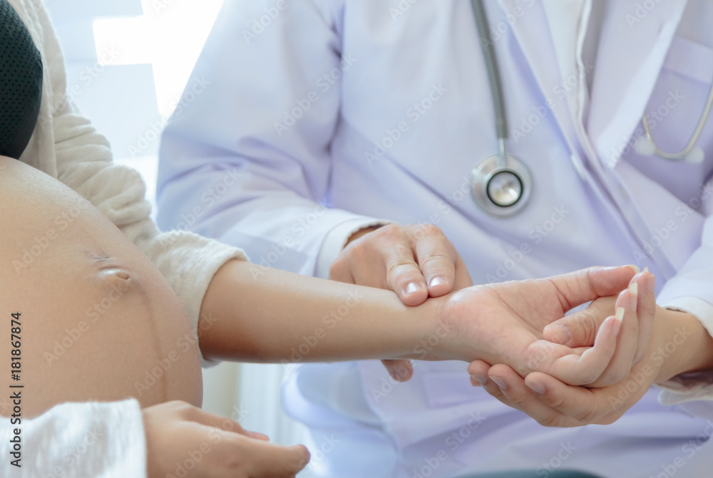 Doctor checking heart rate of a pregnant woman in hospital Doctor checking heart rate of a pregnant woman in hospital