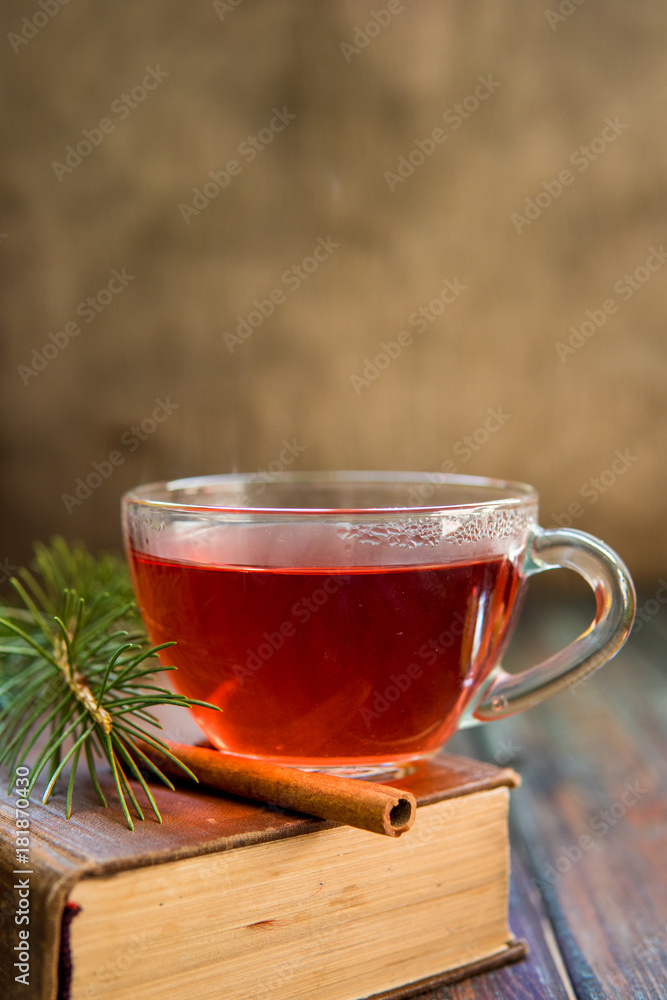 Tea in a glass cup and cinnamon stick Tea in a glass cup and cinnamon stick