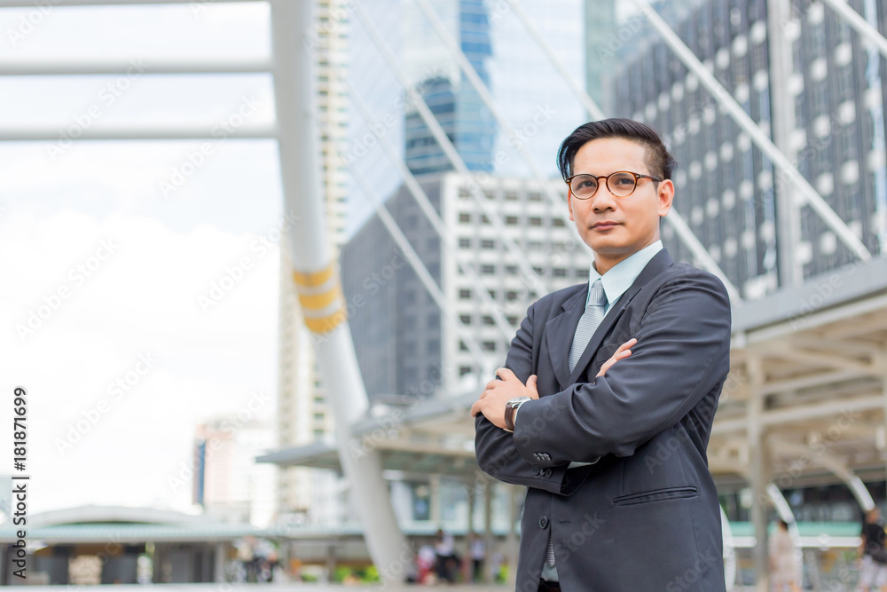 Asia young business man in front of the modern building in downtown .Concept of young business people Asia young business man in front of the modern building in downtown .Concept of young business people