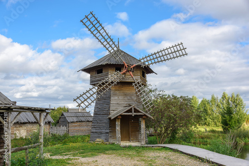 Ancient wooden village mill in summer
