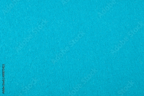 Background texture, pattern. Woolen fabric is turquoise. Felt. Close up view of a turquoise fabric texture and background. Abstract background and texture for designers.
