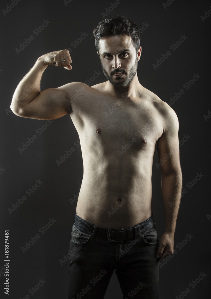 Caucasian guy with fit slim body isolated inside studio