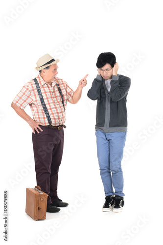 Senior furious father yelling at his son isolated on white background.