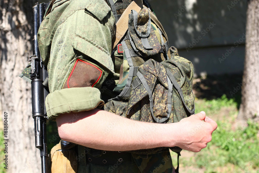 Fototapeta premium One soldier on the city street with weapon