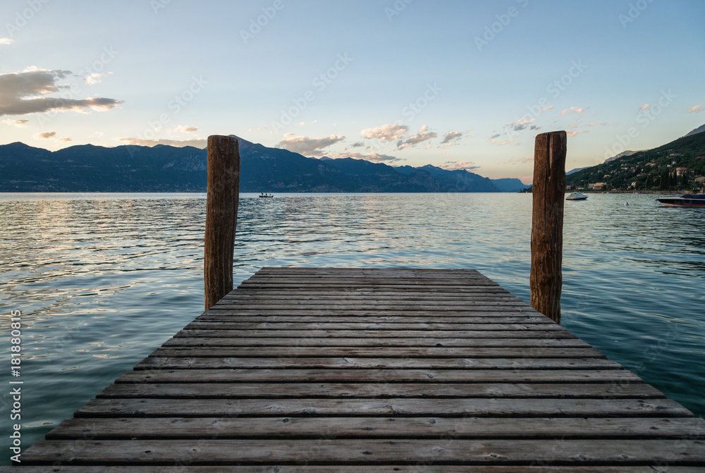 Wooden pier on Garda lake at sunset Wooden pier on Garda lake at sunset