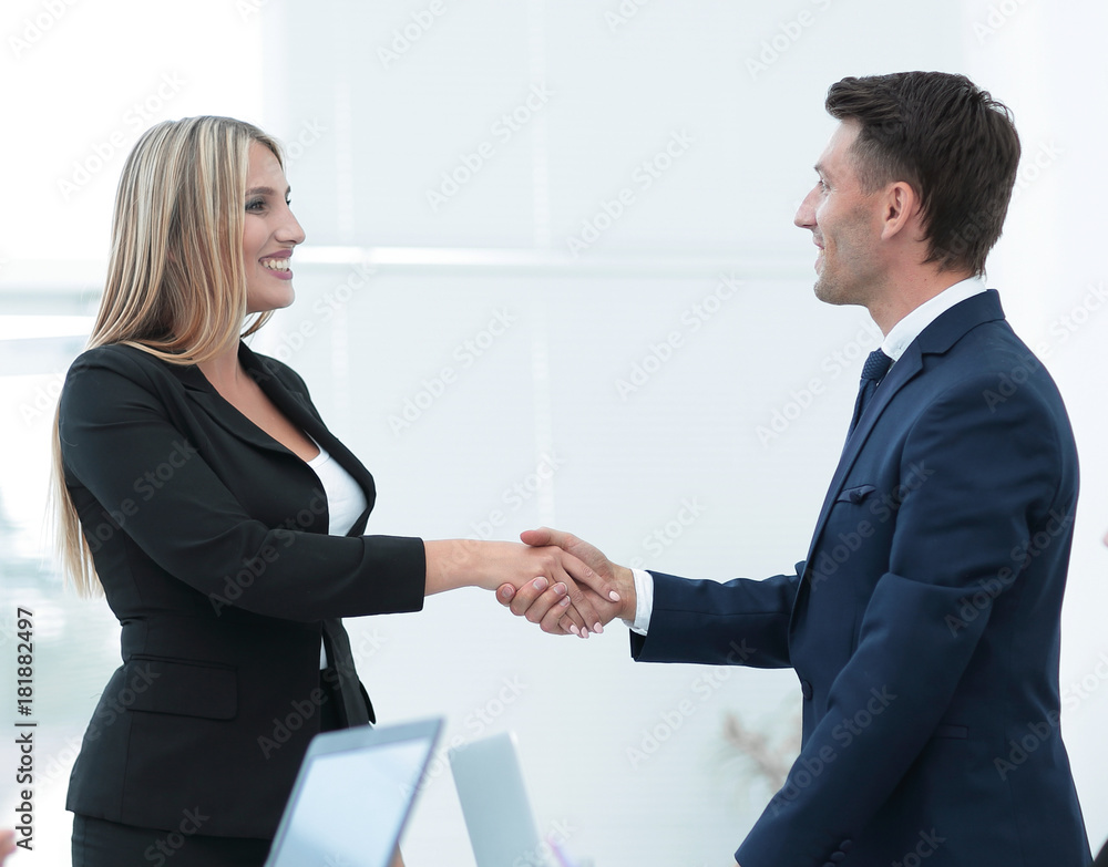 handshake business partners after discussion of the contract