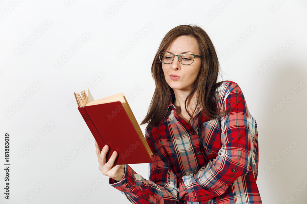 Beautiful European young brown-haired woman in glasses for sight with healthy clean skin dressed in casual red plaid shirt, standing with the book on a white background. Reading and studying concept. Beautiful European young brown-haired woman in glasses for sight with healthy clean skin dressed in casual red plaid shirt, standing with the book on a white background. Reading and studying concept.