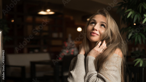 Dreaming young woman in cafe