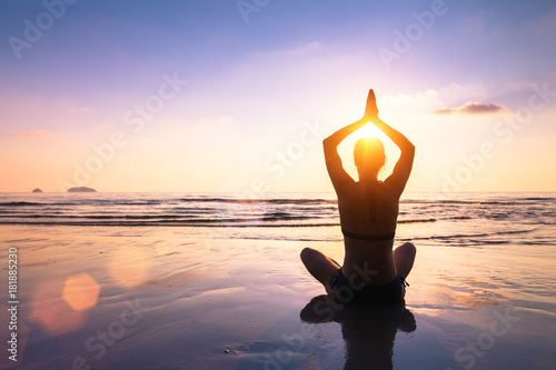 Yoga and meditation calm peaceful beach sunset fit young woman