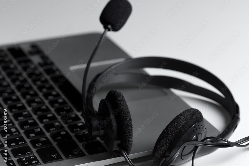 call center support concept. headset on keyboard computer laptop call center support concept. headset on keyboard computer laptop