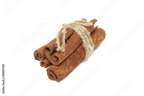 Cinnamon bark tied with rope isolated on white background. close-up.